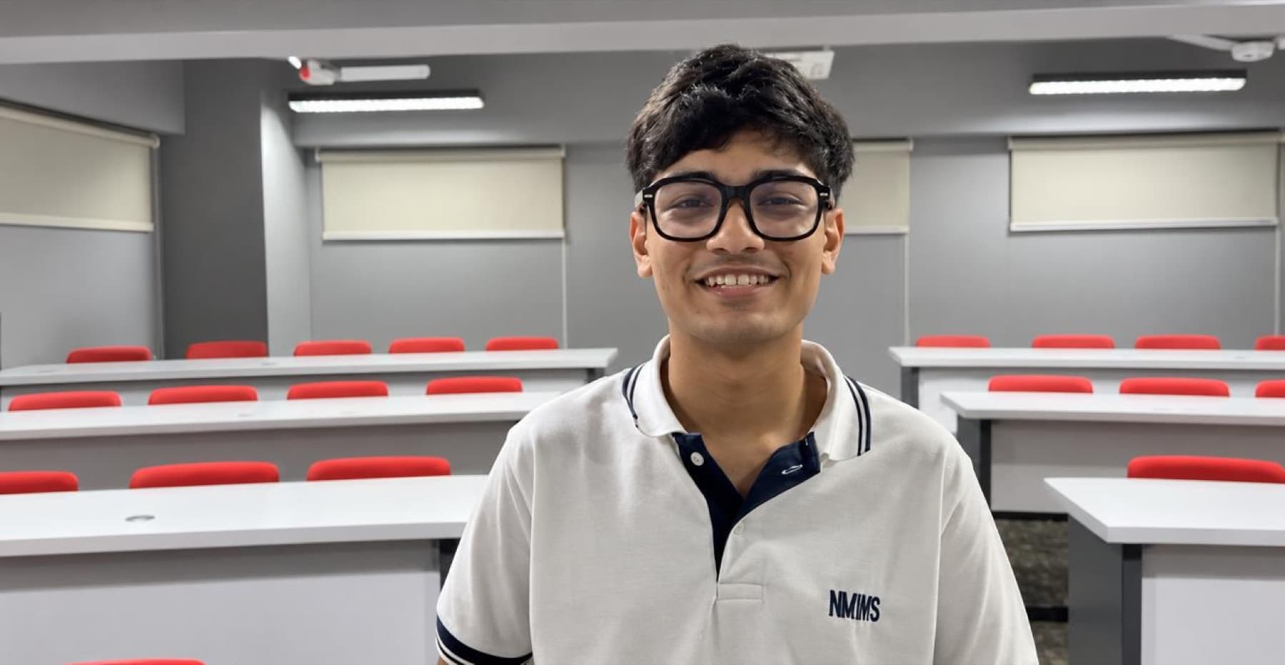 Darsh in an empty auditorium wearing novelty glasses
