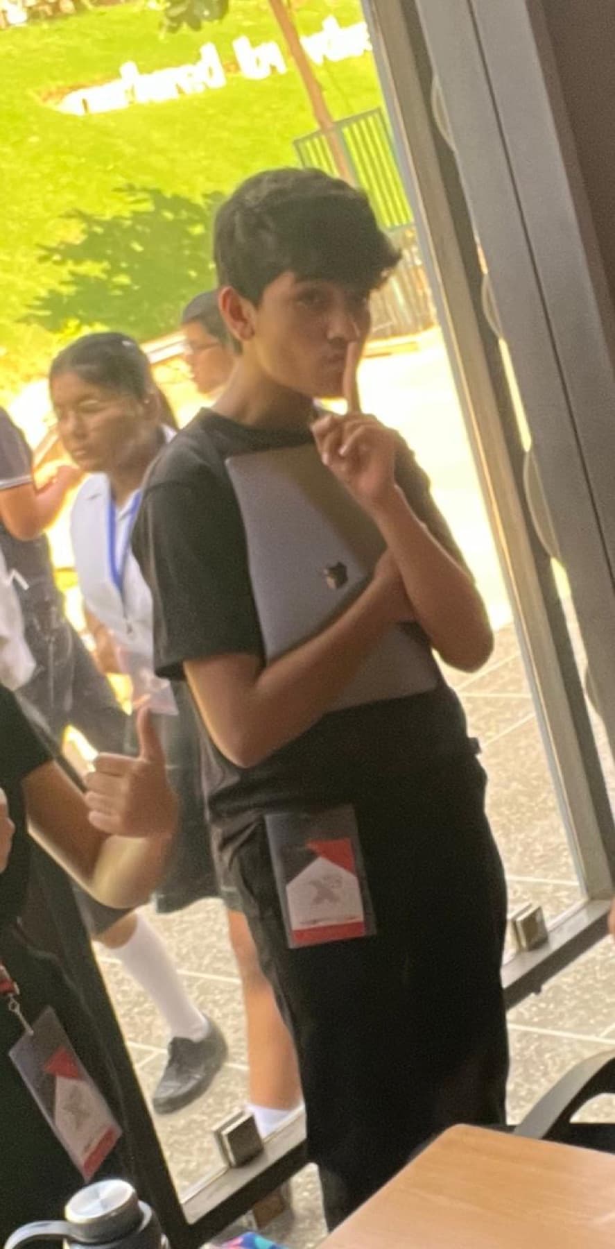 Darsh in a school corridor with an ID lanyard