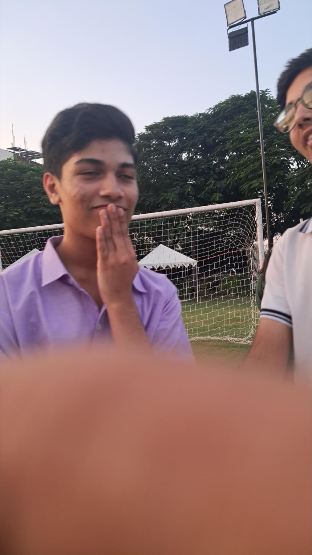 Darsh in a purple shirt on a football field